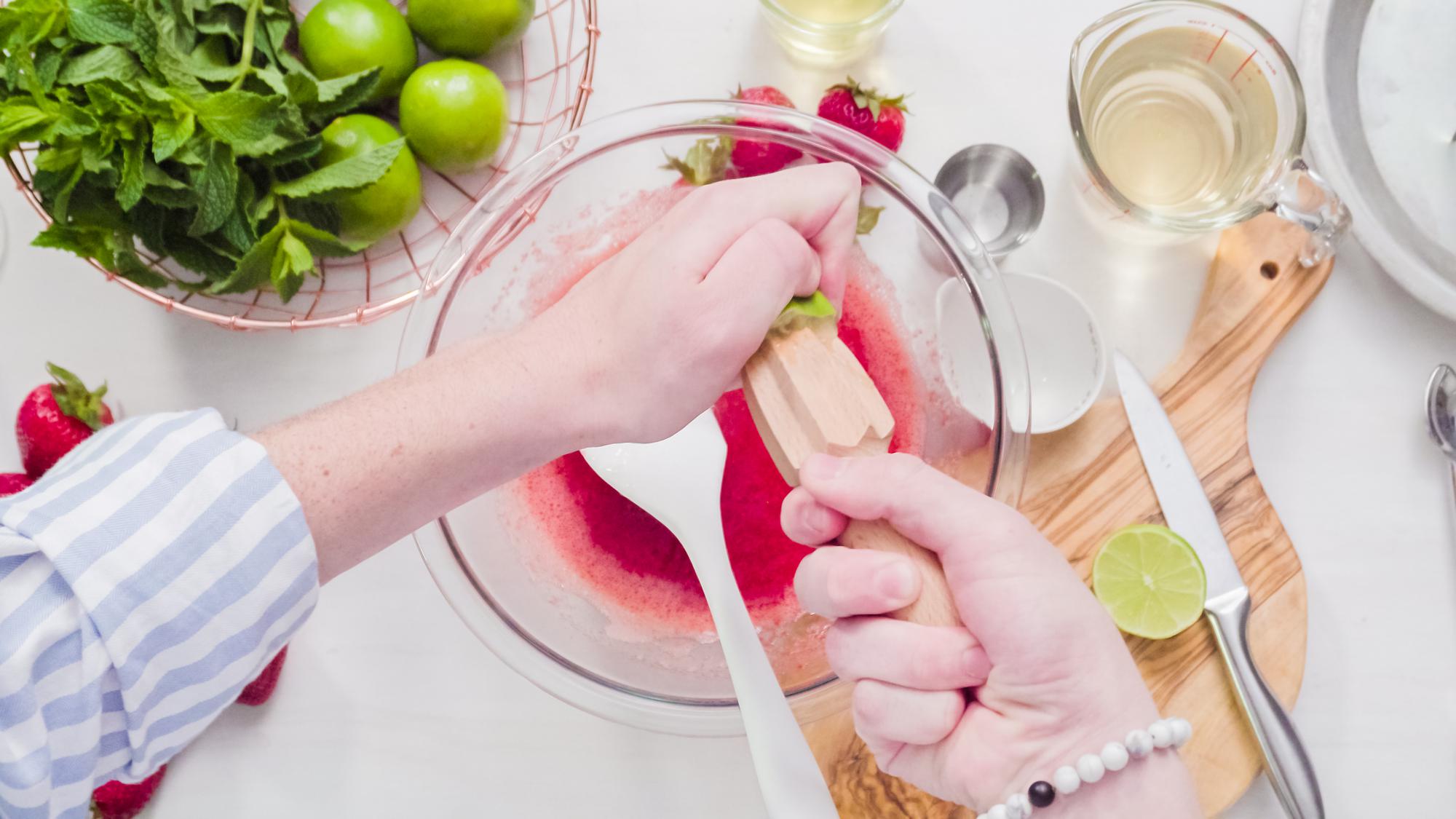Close-up of hands preparing garnish
