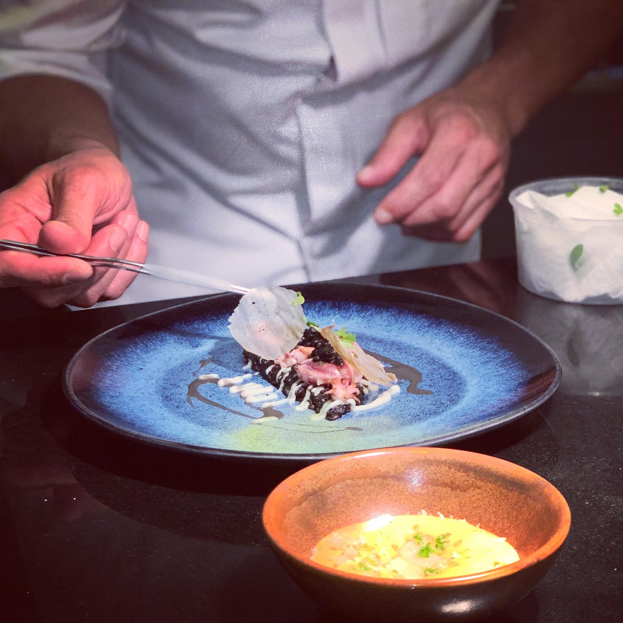 Chef plating a main course